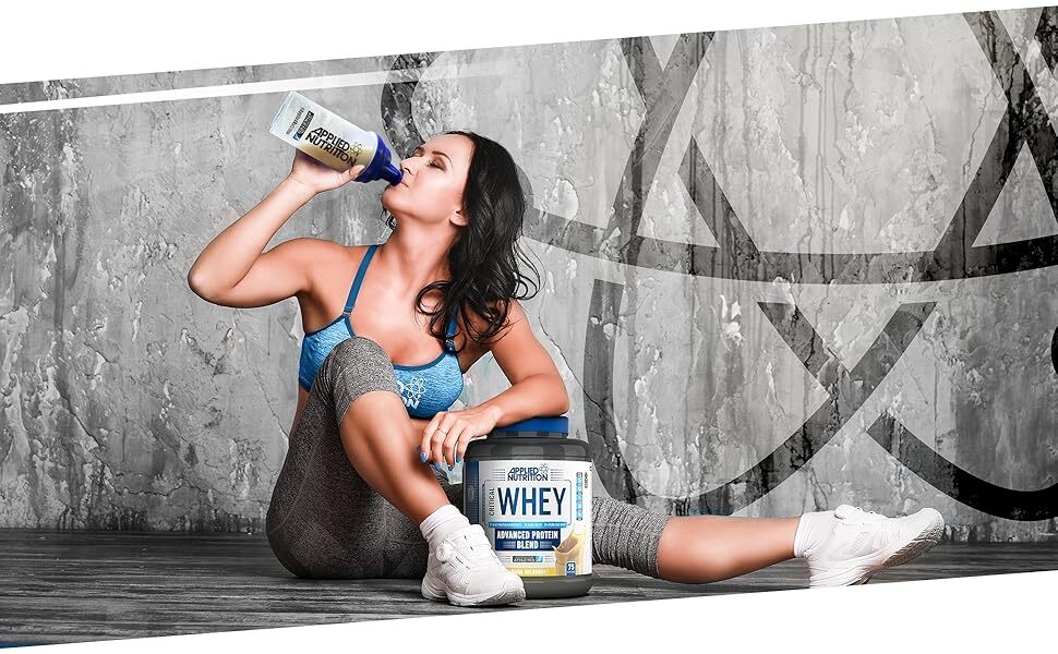 woman drinking a bottle of whey protein