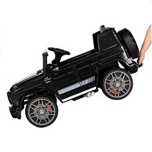 a hand holding a toy car with a person holding it.