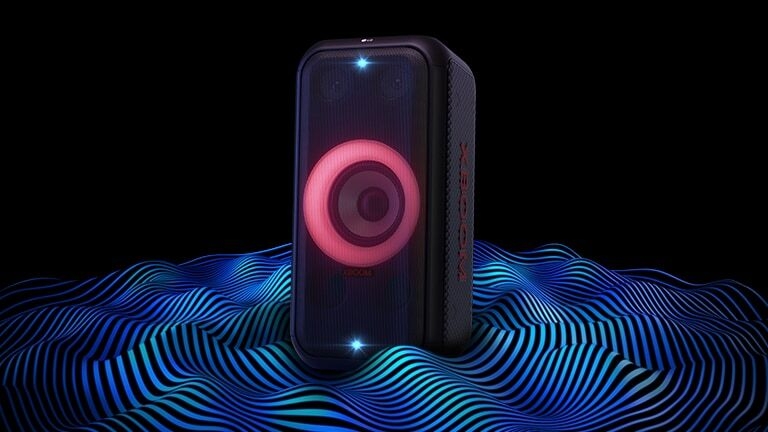 LG XBOOM XL5S is standing on the infinite space. Red woofer lighting and double strobe lightings are on. On top of the speaker a sound eq is displayed. Sound waves are coming out from the bottom of the speaker in order to emphasize its deep bass.