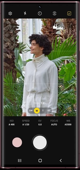 Galaxy S22 Ultra seen from the front with Camera app open onscreen. There is a woman in the frame.