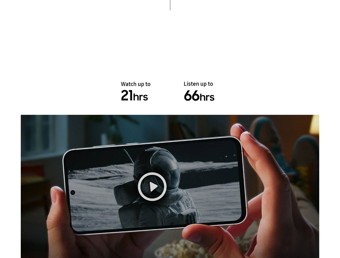 Two hands hold a Galaxy S23 FE device showing the end of a series onscreen. A subtitle reads …