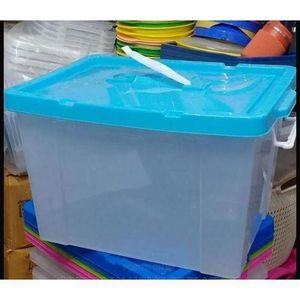 transparent plastic storage box features a bright green lid and ridged side panels.