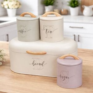 4-piece ceramic kitchen storage set consisting of a bread bin and three canisters for coffee, sugar, and tea. 